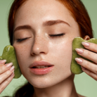 model peforming gua sha on face