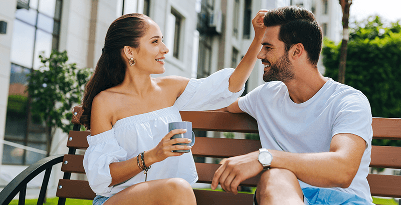 woman running her fingers through man hair