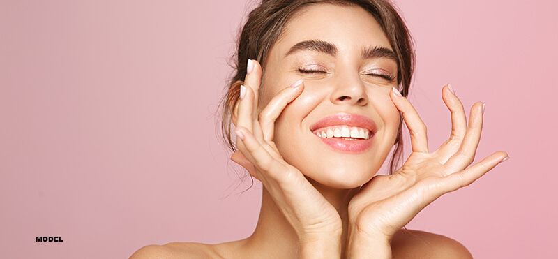 happy woman showing off her clear skin